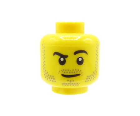 LEGO minifigure head - man, beard stubble, smirk, raised right eyebrow